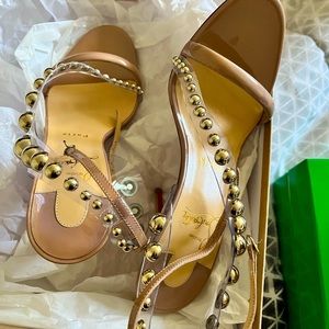 Christian Louboutin nude silver buttons on them